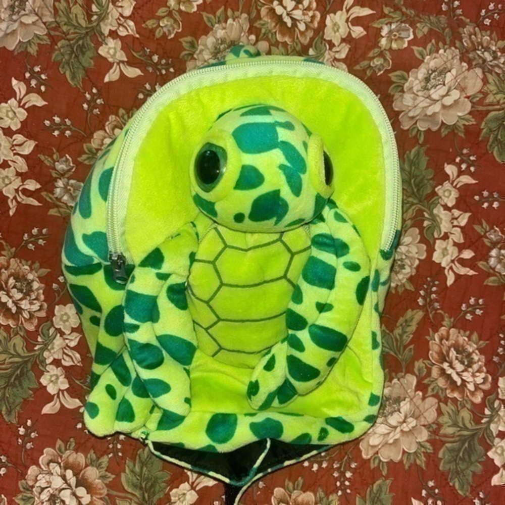 Turtle Toddler backpack. Holds a few small toys.. 9 inches wide, 11 inches long